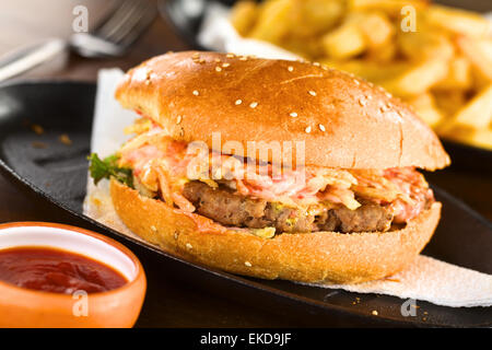 Hamburger auf Metallplatte mit Ketchup und Pommes Frites (selektiven Fokus, Fokus auf der Vorderseite des Hamburgers) Stockfoto