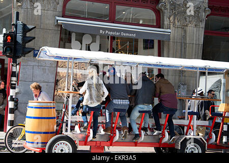 Gruppe von Touristen in die Pedale treten ein Bierbike auf eine Stadtrundfahrt durch Amsterdam. Stockfoto