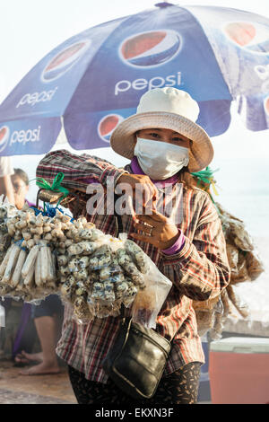 Walking Straßenverkäufer mit lokalen Snacks in Kep, Kambodscha. Stockfoto