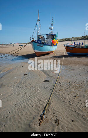 Kleine Fischerboote ausgetrocknet ist, am Sandstrand bei Ebbe. Stockfoto