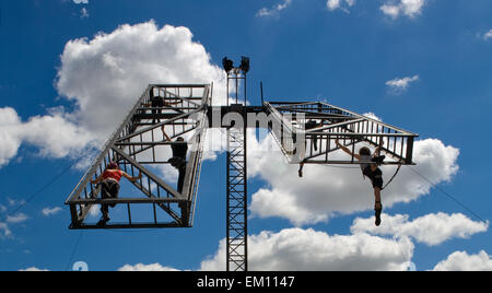 Tänzer führt Luft akrobatische Show mit einem metallischen Platfform auf sky Stockfoto