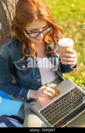 Teenager in der Brille mit Laptop und Kaffee Stockfoto