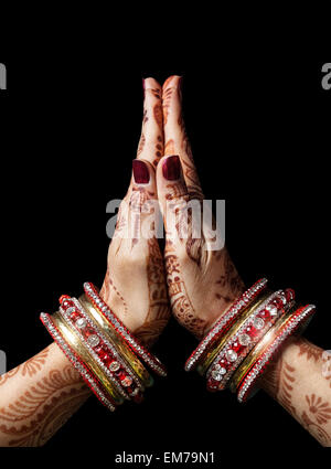 Frau Hände mit Henna im Namaste Mudra auf schwarzem Hintergrund Stockfoto