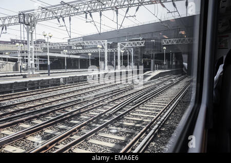 Blick auf die Gleise und Plattformen an der Euston Station, London, von einem Zug wie es kommt. Stockfoto