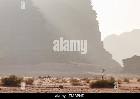 Wadi Rum, Jordanien - März 24,2015: Touristen Kamelreiten bei Sonnenuntergang in der Wüste Wadi Rum, Jordanien Stockfoto