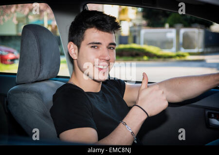 Glücklich Jüngling oder Teenager tun Daumen Auto fahren Stockfoto
