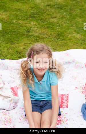 Mädchen auf Decke während Camping Urlaub entspannend Stockfoto