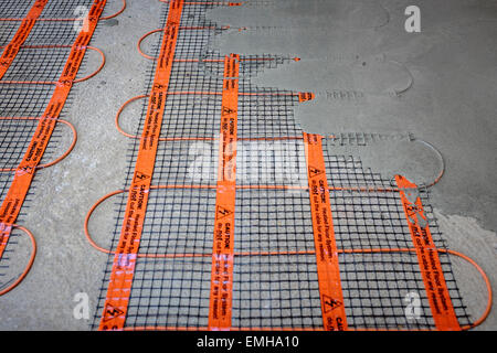 Fußbodenheizung Mat Installation; Self leveling Verbindung auf Estrich Boden angewendet wird, während eine Haus-Renovierung. Stockfoto