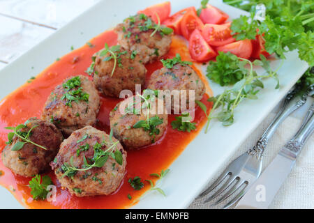 Frikadellen mit frischen Kräutern in Tomatensauce Stockfoto