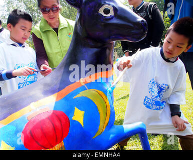 (150422)--SHANGHAI, 22. April 2015 (Xinhua)--Kinder malen eine Skulptur des tibetischen Antilopen im Zoo in Shanghai, Ost-China, 22. April 2015. Eine Aktivität, die die Aufmerksamkeit der Menschen zum Schutz der tibetischen Antilopen gefordert wurde am Mittwoch in Shanghai Zoo organisiert.   (Xinhua/Chen Fei) (Zhs) Stockfoto