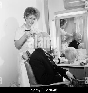 Schauspieler William Hartnell - der erste Arzt - abgebildet in Umkleidekabine wie Mke Maskenbildner Sonia Markham den letzten Schliff auf seinem Gesicht Make-up & Perücke im BBC Television Centre, Wood Lane 9. Januar 1966 angewendet wird. An diesem Samstag (15. Januar) wird die Ausstrahlung zu sehen, ob der 100. Dr Who Episode. Stockfoto