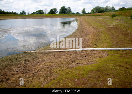 Bewässerung Rohr Wasser Stausee auf niedrigem Niveau im Sommer Sutton, Suffolk, England Stockfoto