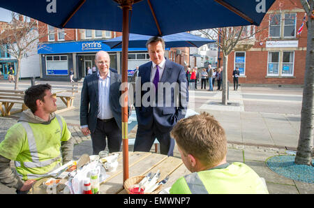 Premierminister David Cameron in Barnstaple, Devon bei den allgemeinen Wahlen Wahlkampf 2015 treffen Arbeitnehmer vor einem Café. Stockfoto