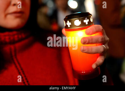 Berlin, Deutschland. 23. April 2015. Eine junge Frau hält eine brennende Kerze in der Hand während der sogenannten "Lichterzug der Vergessenen" (lit. leichte Prozession für die vergessenen) in Berlin, Deutschland, 23. April 2015. Die Prozession erinnert an den 100. Jahrestag des Beginns der Massaker an den Armeniern im Osmanischen Reich. Foto: Britta Pedersen/Dpa/Alamy Live News Stockfoto
