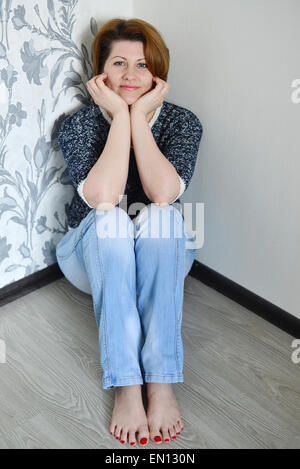 Reife Frauen, die in den Boden seines neuen Hauses gelegen Stockfoto