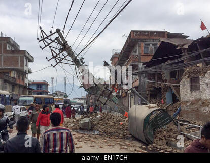 Kathmandu, Nepal. 25. April 2015. Fußgänger gehen vorbei an eingestürzten Gebäuden in Kathmandu, Nepal, 25. April 2015. Mehrere hundert Menschen starben bei einem schweren Erdbeben in der Region. Foto: Arne Adrian/Dpa/Alamy Live-Nachrichten Stockfoto