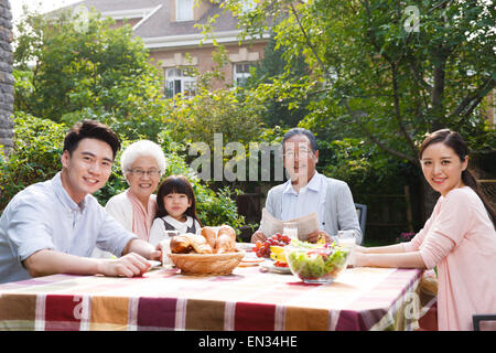 Glückliche Familien frühstücken im freien Stockfoto