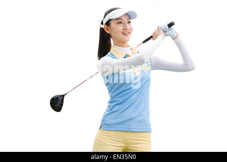 Die junge Frau, die Golf spielen Stockfoto
