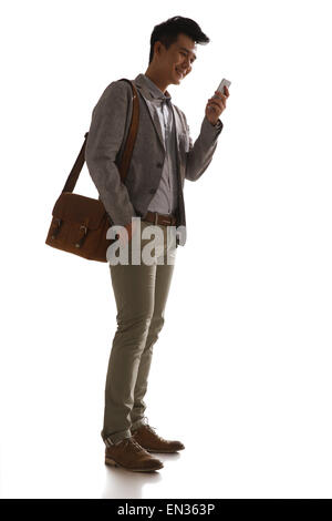 Der junge Mann bei der Nutzung des Mobiltelefons Stockfoto