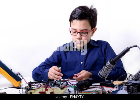 Junger Student führt Experimente in der Elektronik und Träume für die Zukunft. Stockfoto