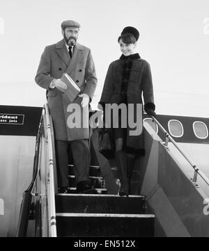 Schauspielerin Audrey Hepburn im Bild mit ihrem Ehemann Mel Ferrer Ankunft in London von Zuruch für den Royal Charity Premiere ihres neuesten Films "My Fair Lady", zu dem Warner Theatre statt. 19. Januar 1965. Stockfoto