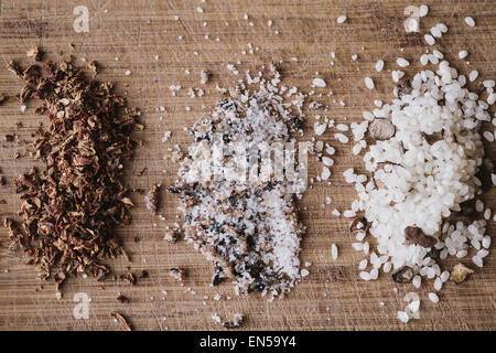 Trüffel Salz, schwarzer Trüffel-Risottoreis und trockenem Boden Girolle Pilze auf einer Holzoberfläche Stockfoto