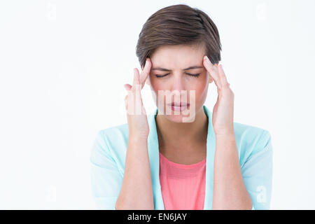 Brünette Frau mit Kopfschmerzen Stockfoto