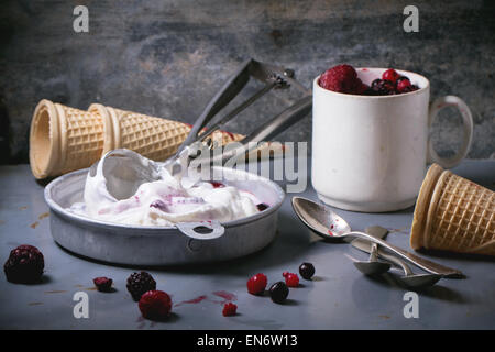 Aluminium-Platte mit Vanilleeis, Mischung aus gefrorenen Beeren und Zapfen Waffer, serviert mit Metalllöffel über Metall-Tisch. Sehen se Stockfoto