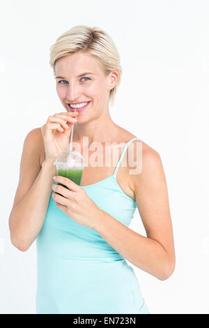 Schöne Frau grünen Saft trinken Stockfoto