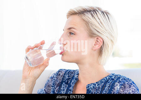 Hübsche blonde Frau Glas Wasser trinken Stockfoto