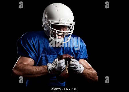 Fußballspieler mit auf eine blaue Uniform und ein Ball in der Hand. Studio gedreht. Stockfoto