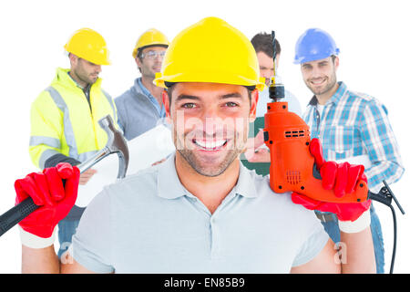 Zusammengesetztes Bild glücklich Mechaniker hält Hämmern und Bohren Maschine Stockfoto