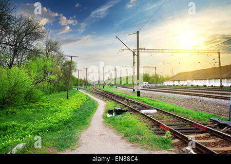 Strommasten auf einem Bahnhof bei Sonnenaufgang Stockfoto