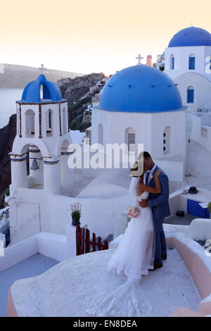 Brautpaar mit traditionellen Kirche in Oia, Santorini, Griechenland Stockfoto