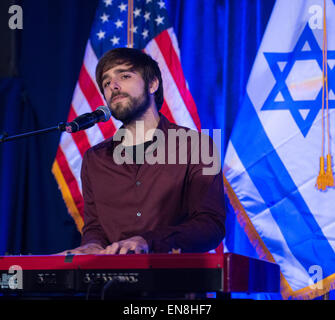 Tal Ramon, überlebende Sohn Ilan Ramon, Columbia Astronaut führt "Hatikwa", die Nationalhymne Israels bei der Einweihungsfeier des Space Shuttle Enterprise Montag, 27. April 2015 bei der Intrepid Sea, Air &amp; Space Museum in New York City. Unternehmen widmete sich die gefallenen Crews, die ihr Leben bei der Verfolgung des Weltraums auf der Apollo 1, Challenger und Columbia Weltraum-Missionen.   (NASA/Bill Ingalls) Stockfoto