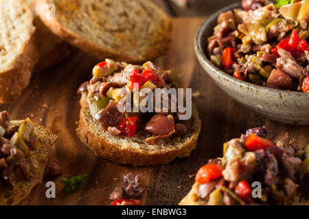 Hausgemachte gemischte Oliven Tapenade auf Vollkorn-Crostini Stockfoto