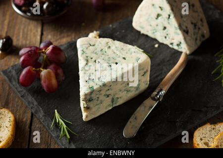 Bio Blauschimmelkäse Keil mit Oliven und Trauben Stockfoto