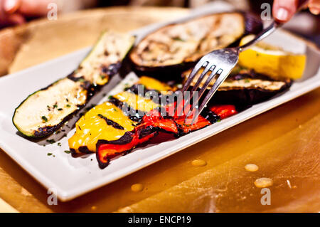 Paprika, Zucchini und gegrillte Auberginen auf dem Grill und gewürzt mit Salz, Olivenöl und Gewürzen Stockfoto