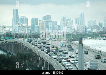 Miami Stadtbild - Schwerverkehr über eine Brücke mit Miami Skyline im Hintergrund Stockfoto