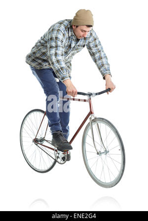 Junger Mann macht Tricks mit dem Fahrrad auf weißem Hintergrund Stockfoto