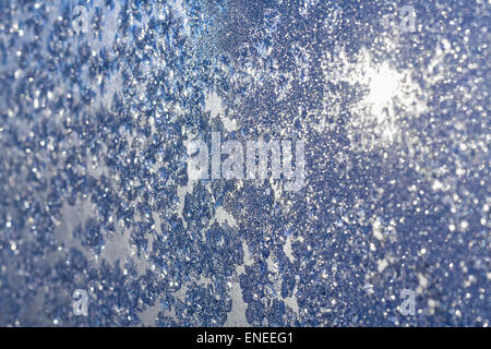 Eis und Frost Hintergrund über die Sonne auf gefrorene Fenster. Farbige in Blauton Stockfoto