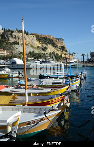 Traditionelle hölzerne Fischerboote, bekannt als Pointus, in Cassis Hafen oder Hafen & Cap Canaille Klippen Provence Frankreich Stockfoto