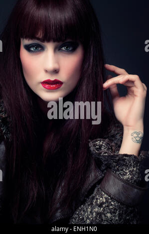 Mode-Porträt der jungen Frau mit langen dunklen Haaren und roten Lippenstift Stockfoto