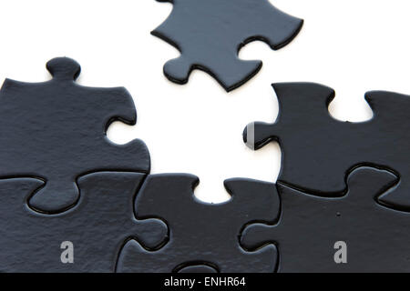 schwarze und weiße Puzzleteile kontrastierenden Stockfoto