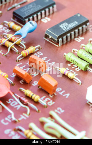 Nahaufnahme von elektronischen Bauteilen auf eine veraltete Platine Stockfoto