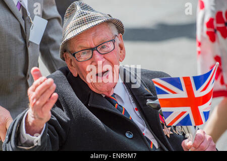 Viele der Veteranen sind im Rollstuhl geschoben von Personal aus den Streitkräften und Notdienste. VE Tag 70 Gedenkfeiern - historischen Jahrestag des Endes des zweiten Weltkrieges in Europa. Anschluss an ein Service von Thanksgiving in der Westminster Abbey, eine Parade von Service-Personal und Veteranen, geführt von einer militärischen Rohr-Band und einen Durchflug - in Horse Guards Parade und Whitehall. Stockfoto