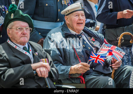 Viele der Veteranen sind im Rollstuhl geschoben von Personal aus den Streitkräften und Notdienste. VE Tag 70 Gedenkfeiern - historischen Jahrestag des Endes des zweiten Weltkrieges in Europa. Anschluss an ein Service von Thanksgiving in der Westminster Abbey, eine Parade von Service-Personal und Veteranen, geführt von einer militärischen Rohr-Band und einen Durchflug - in Horse Guards Parade und Whitehall. Stockfoto