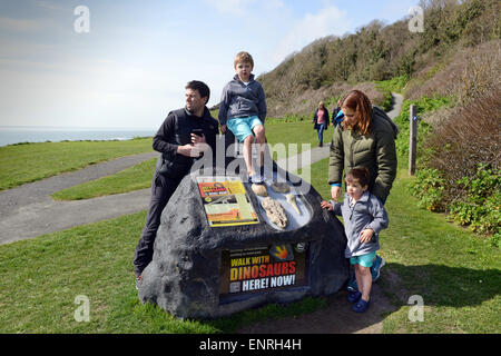 Familie mit Kindern zu Fuß kommen mit Dinosaurier-Spuren auf der Isle Of Wight-Uk Stockfoto