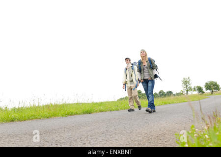 Wandern junge Paar Rucksack Asphalt Straße Landschaft Stockfoto