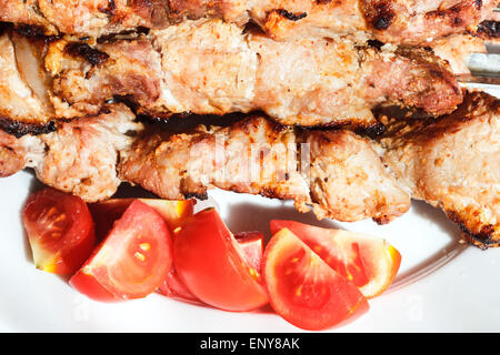 Stücke von rote Tomate und Schaschliks am Spieß auf Platte hautnah Stockfoto